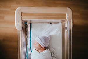 Newborn in a hospital bassinet