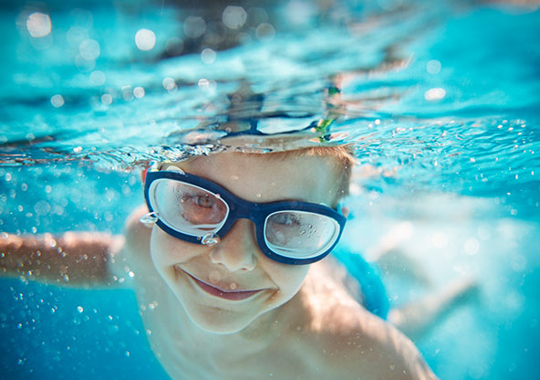 Little boy swimming under water