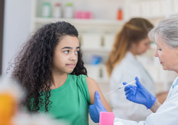 Teen girl getting vaccine