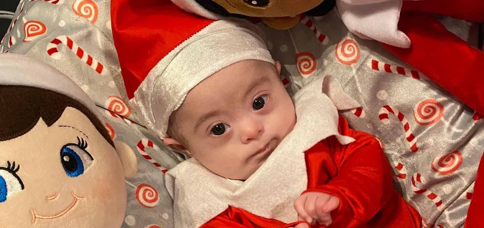 A baby in a Santa costume