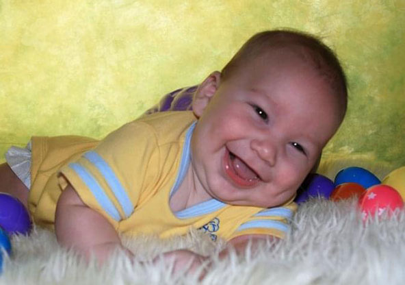 Kaden Hickman smiling when he was a baby