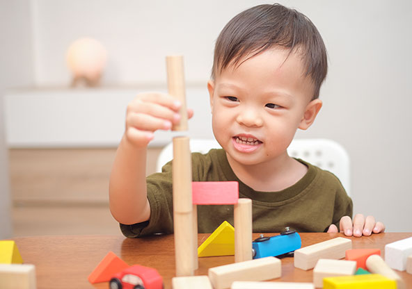 Toddler boy playing with blocks