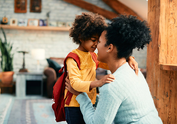 A mom gets her daughter ready for the first day of school