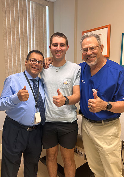 Thomas F. smiling with his doctors after his neurosurgery