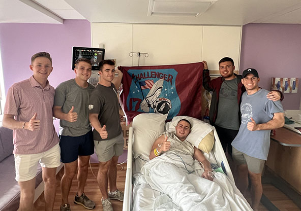 Thomas F. in his hospital room after his neurosurgery, surrounded by his friends.