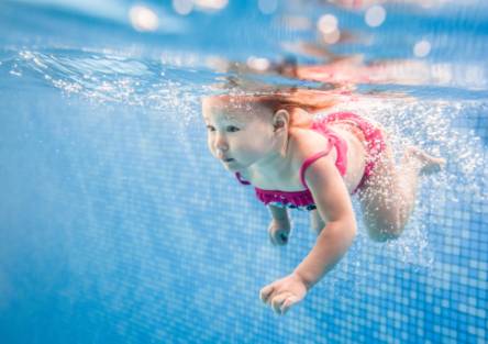 A girl swims in a pool