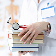 Doctor holding medical books and stethoscope