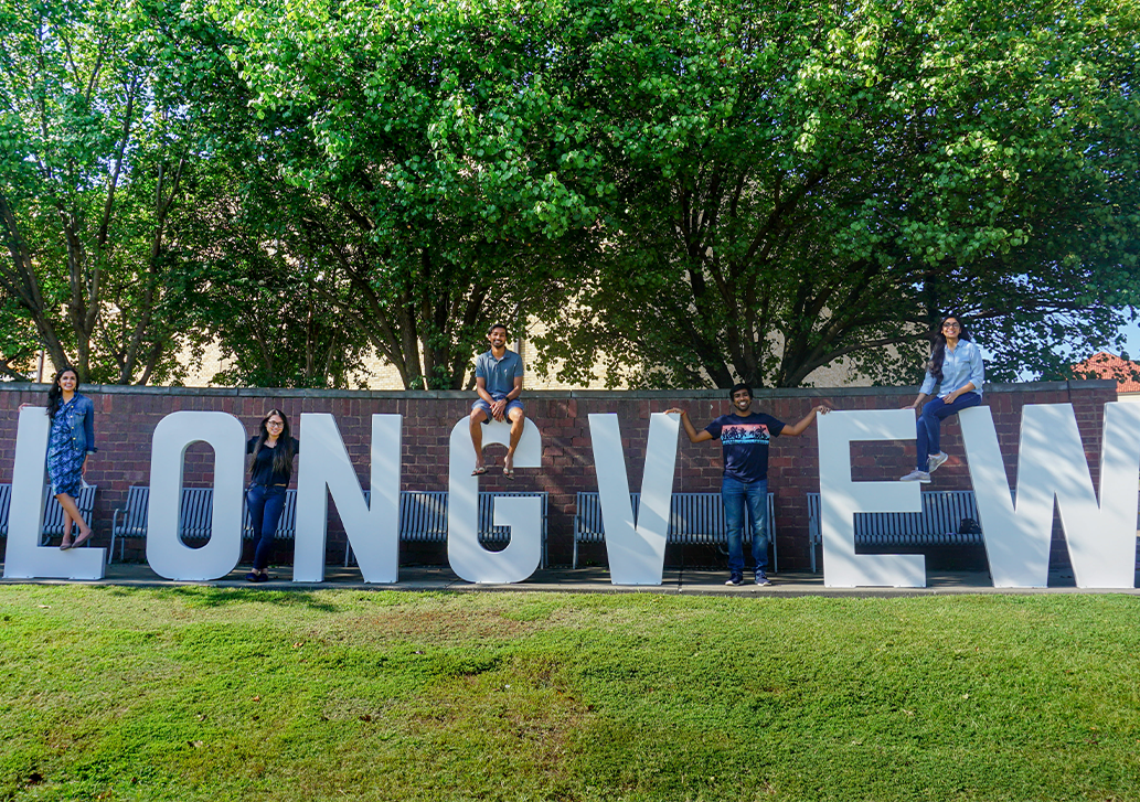 A group of residents standing by the Longview letters