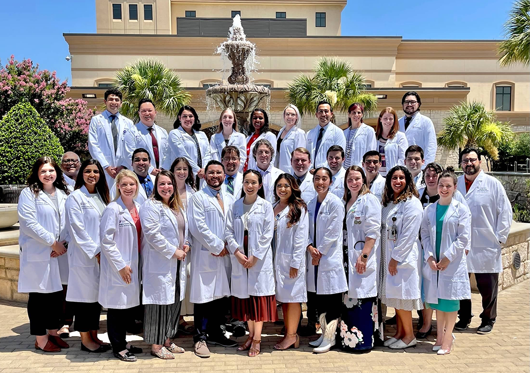A group of CHRISTUS Santa Rosa's residents in their white lab coats
