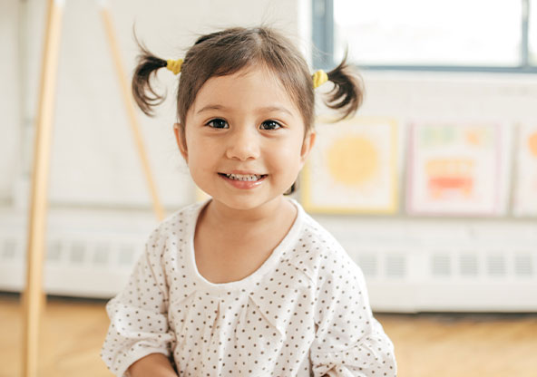 A happy and smiling little girl in piggy tails