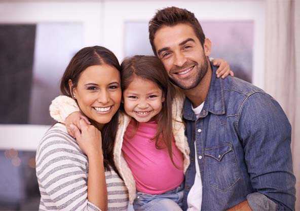 A young Hispanic family smiling