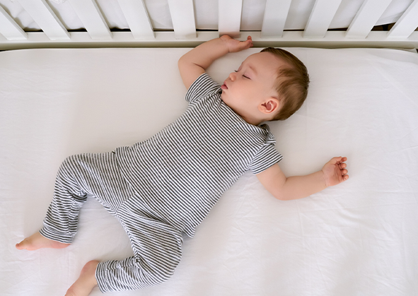 A sleeping baby in a crib