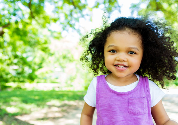 A young African American toddler smiling