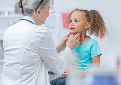 Doctor feeling a child's neck glands