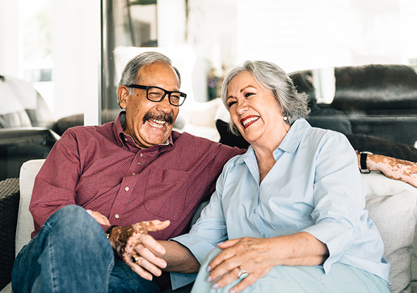 A healthy senior Latino couple laughing