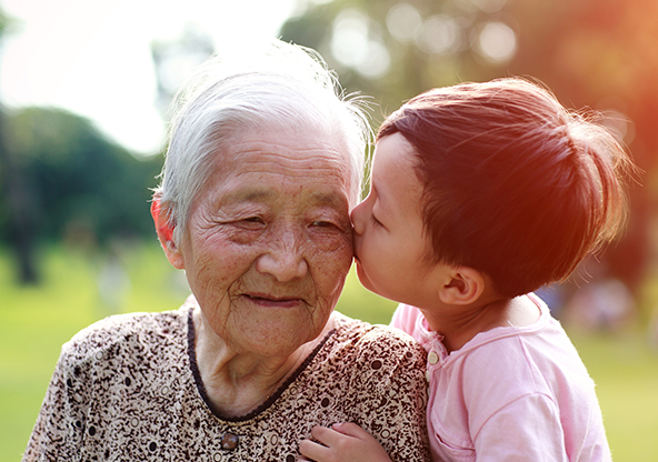 An Asian senior with heart issues with her grandson