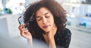 Young woman experiencing pain in her neck