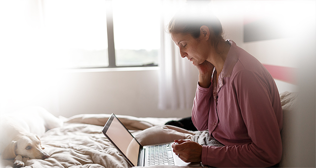 woman on laptop with her dog