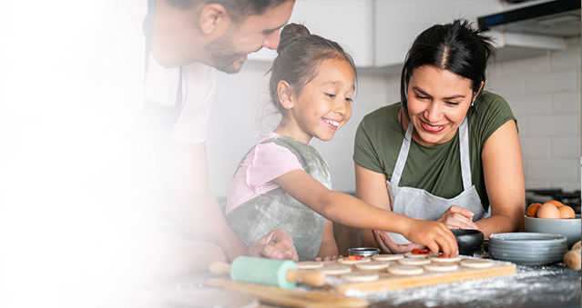 Daughter and parents baking cookies