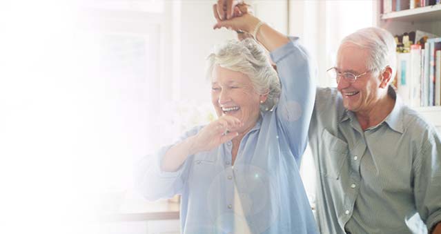 Older couple dancing in the kitchen