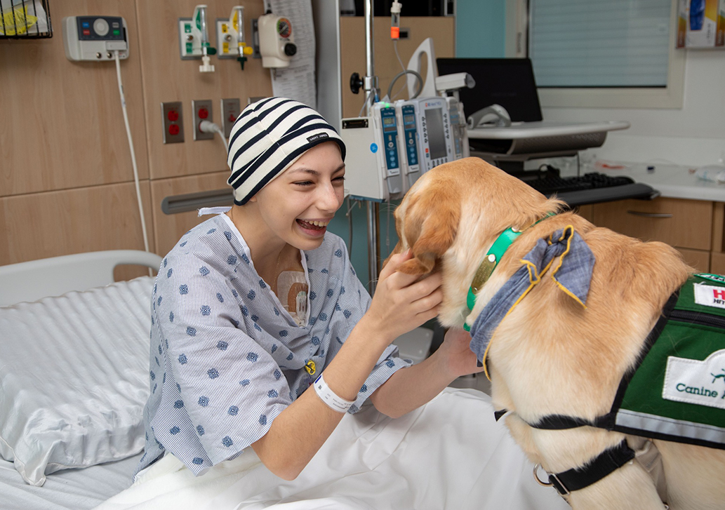Golden Retrieve Marcus entertaining one of our patients at The Children's Hospital of San Antonio