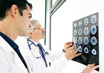 Two male neurologist looking at an MRI.