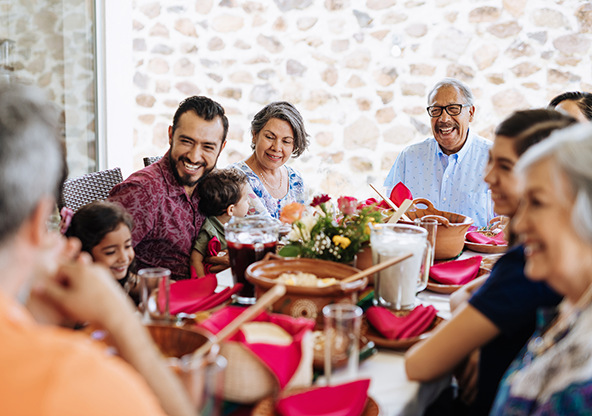 A multi-generational Latino family eating dinner together